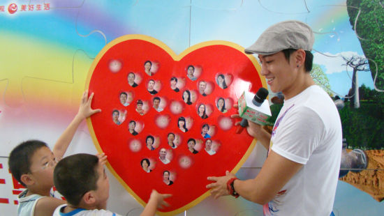 何润东与小朋友贴爱心墙